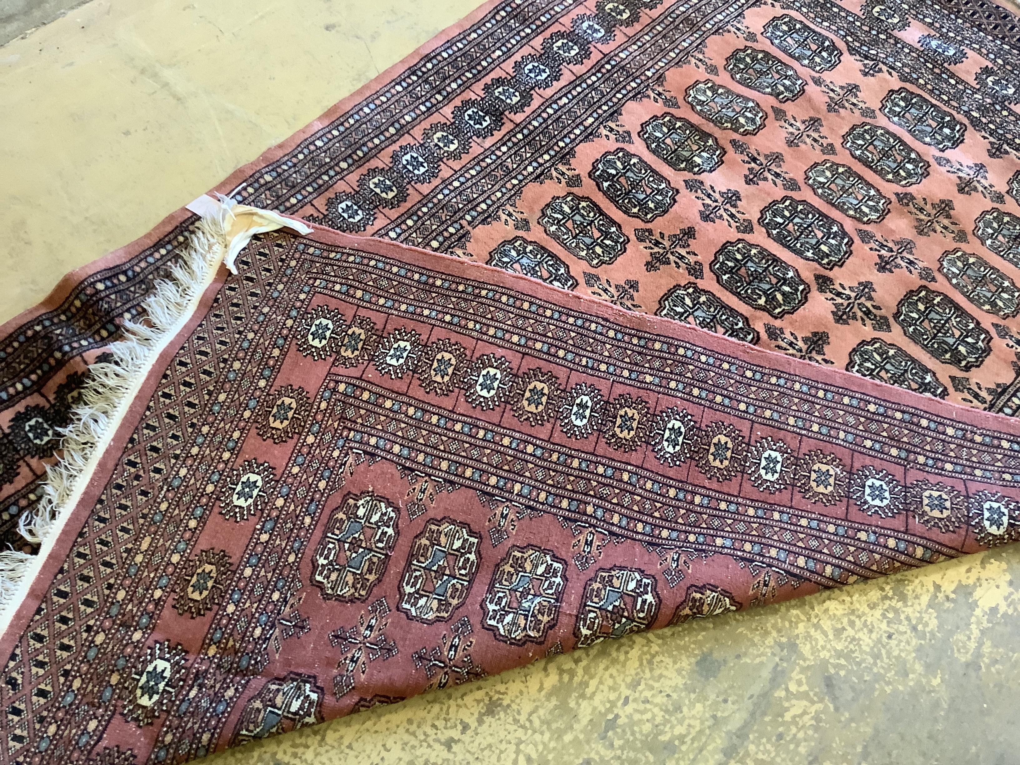 A Bokhara peach ground rug, 190 x 124cm